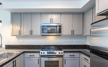 A modern kitchen with a stove top oven and microwave.